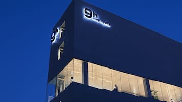 A modern building with illuminated signage reading '9h Nineteen'.