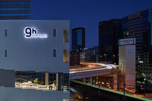 A modern building with a sign reading '9h nine hours' and a view of a busy urban street with a bridge. - 9h nine hours Suidobashi (Tokyo)