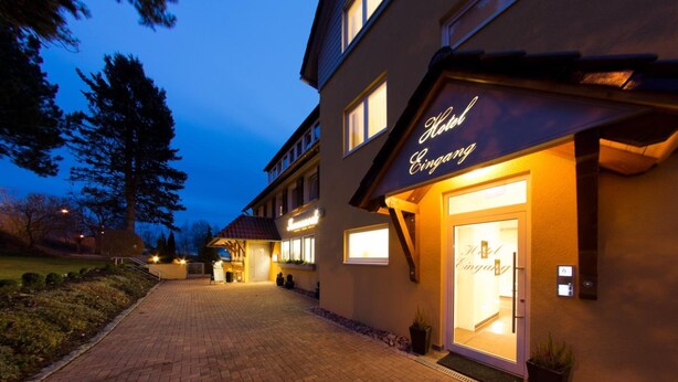 A hotel entrance with a well-lit sign reading "Hotel Eining." - Hotel-Restaurant Sonneneck (Dornstetten)