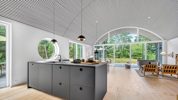 A modern kitchen with a central island, large windows, and a view of the outdoors. - 2 bedroom amazing home in Vig (Vig)