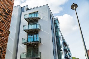 Ein modernes Gebäude mit mehreren Balkonen und großen Fenstern.