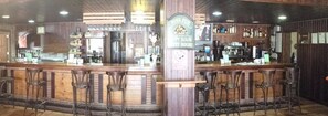 A bar area with wooden bar counters, stools, and a sign indicating a happy hour. - Hostel Restaurant Leyvamar (Guadahortuna)
