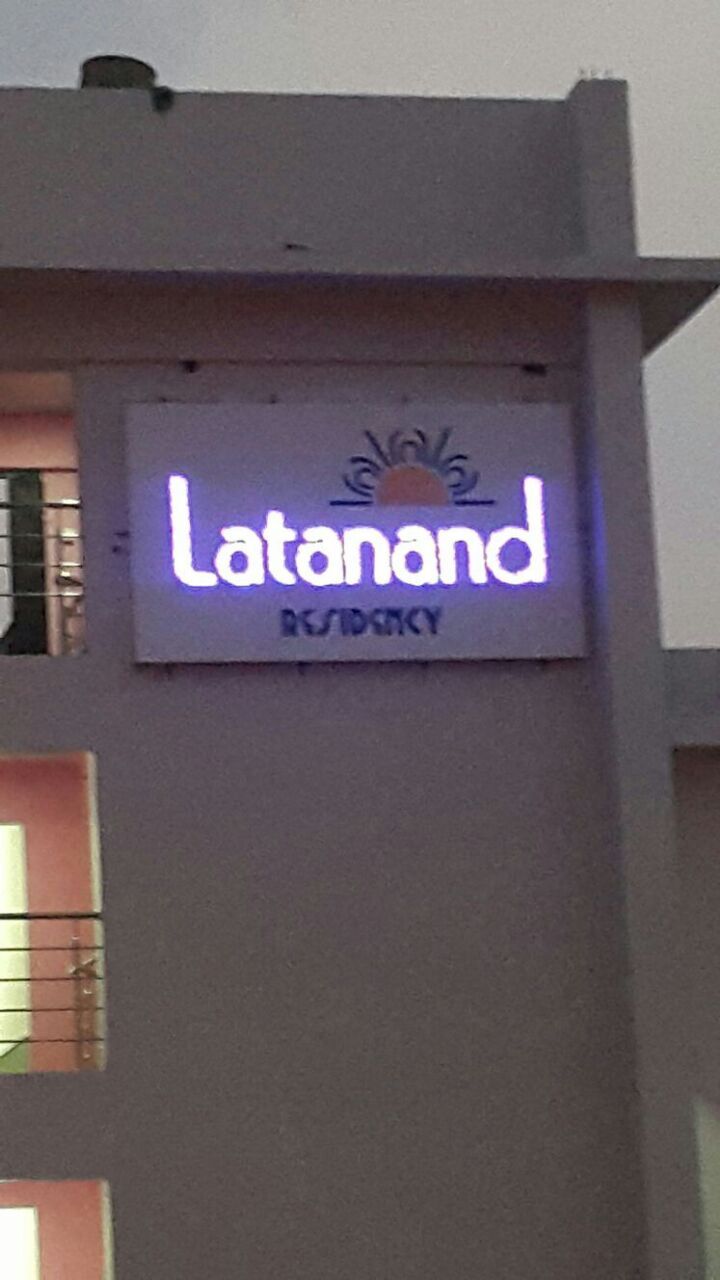 A sign for 'Latanaand RESIDENCY' with a simple, clear font on a light background.