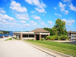Surrounded by lush greenery and a serene body of water, this property offers a peaceful retreat.