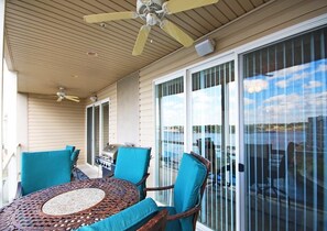 Enjoy dining al fresco in this serene outdoor space with a round table and comfortable seating.