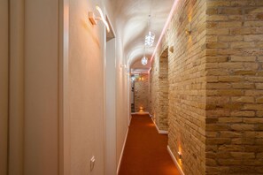 A hallway with a brick wall and a carpeted floor. - The Key (Kyiv)