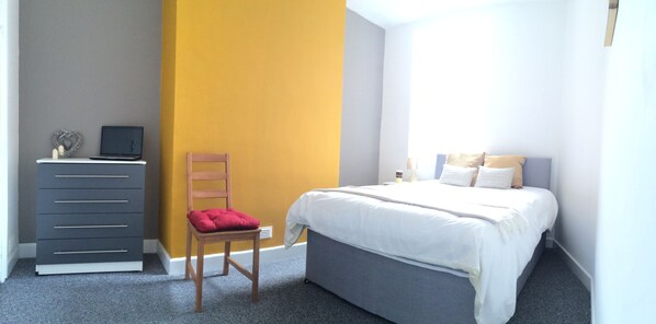 A bedroom with a bed, a desk with a laptop, a chair, and a dresser. - Crewe Rooms @ 97 Edleston Road (Crewe)
