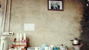 A kitchen counter with various items including a kettle, toasters, jars, and a pot. - Phu Fa Sai Homestay (Mae Rim)