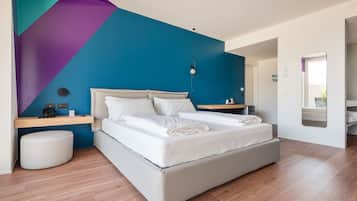 A modern bedroom with a bed, bedside tables, and a nightstand.