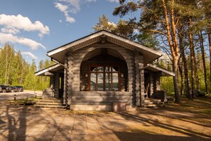 A log cabin with a porch, large windows, and a stone pathway leading to it. - Holiday Village Kukkapää (Sulkava)