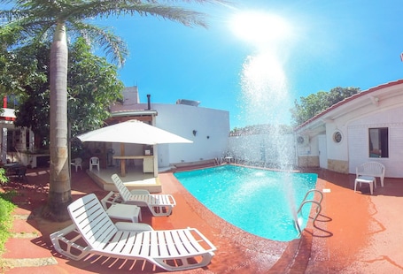 Outdoor pool, open 9:30 AM to 9:30 PM, pool umbrellas, sun loungers. Hotel Maison Suisse