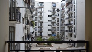 A multi-story residential building with balconies, air conditioning units, and a courtyard with planters. - Apartment on Ingorokva St. 19 (Tbilisi)