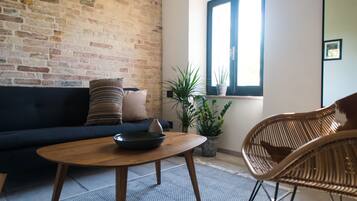 Deluxe Suite (12) | Living area | 48-inch Smart TV with premium TV channels, TV, Netflix