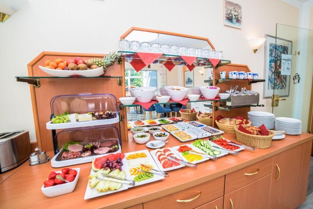A buffet setup with various food items and utensils.