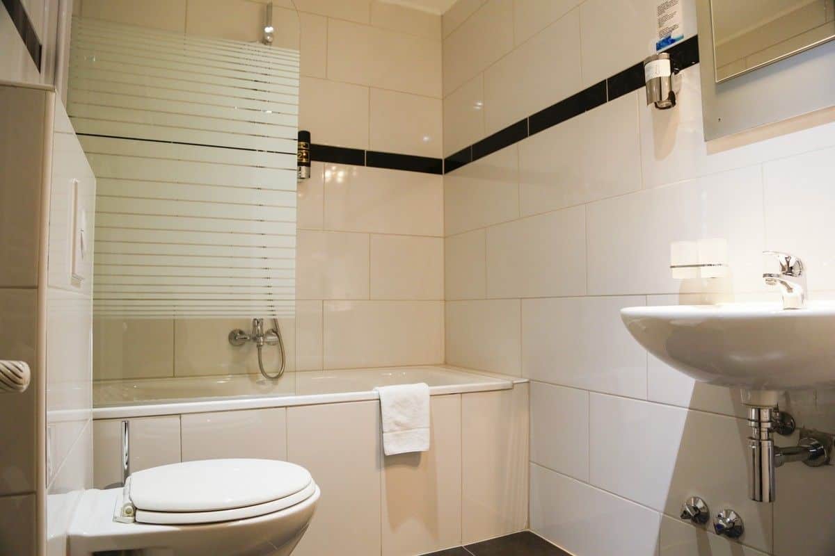 A modern bathroom with a bathtub, toilet, and sink.