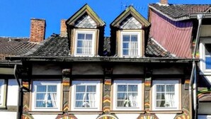 A multi-story building with a traditional architectural style, featuring ornate window frames and decorative elements.