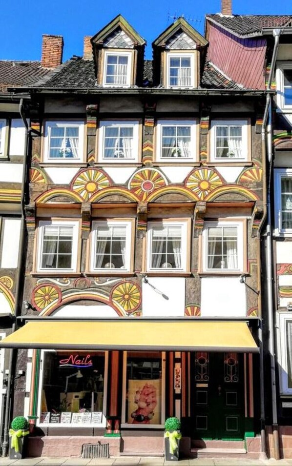 A multi-story building with a traditional architectural style, featuring ornate window frames and decorative elements.