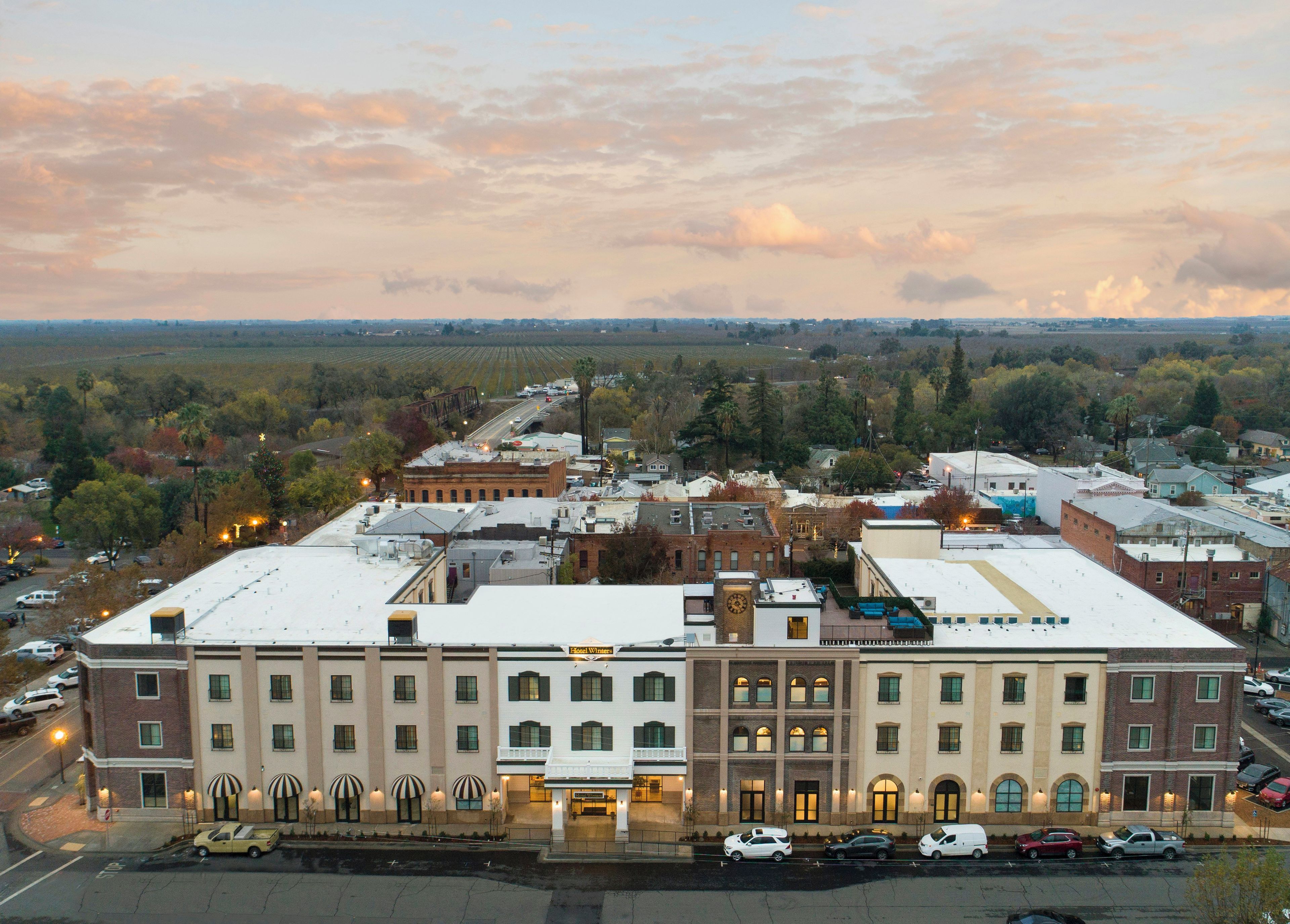 A hotel with a flat roof, multiple stories, and a central entrance.
