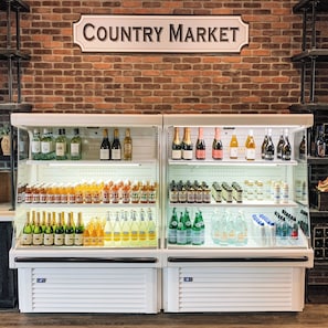A refrigerated display case labeled "Country Market" with various beverages and health drinks.