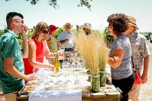A group of people at an outdoor event with a table set up for a meal or gathering.