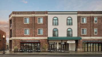 A two-story building with a brick facade, a green awning, and a storefront labeled 'CARBONI'S'.