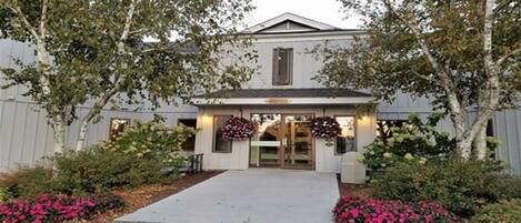 A building with a symmetrical facade, a central entrance, and a small porch area.