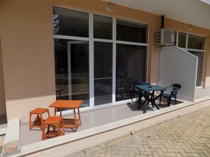 Relax in the outdoor seating area with two tables and comfortable chairs.