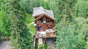 A wooden cabin with a balcony, surrounded by dense forest. - Hot Tub Cabin - Secluded Forest Acreage, 18mi to Breck (Alma)