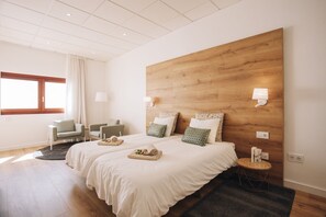 A modern hotel room with two beds, a wooden headboard, a small round table, a chair, and a window with curtains. - THE HOUSE OF LINA :) (Garachico)
