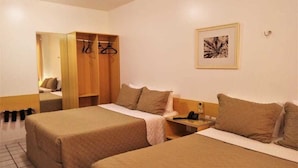 A hotel room with two beds, a wardrobe, a bedside table with a phone, and a framed picture on the wall. - Hotel Rio Parnaiba (Floriano)