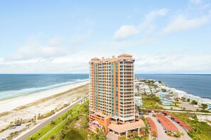 A high-rise hotel with multiple balconies overlooking a beach and ocean. - Spacious 18th-Floor Sky Home | Sleeps 8 | Sunset & Water Views (Pensacola Beach)