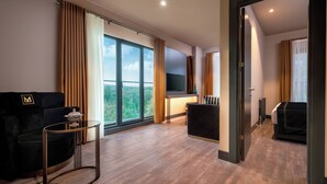 A modern hotel room with a large window, a sofa, a TV, and a small table. - Menalo Hotel Premium Istanbul Airport (Arnavutköy)