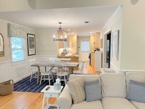 Enjoy a spacious living area with a dining table, sofa, and kitchen view.
