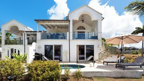 A two-story house with a swimming pool, outdoor seating, and a covered patio. - Sunset Views and Private Pool - Sugar Cane 1 (Westmoreland)