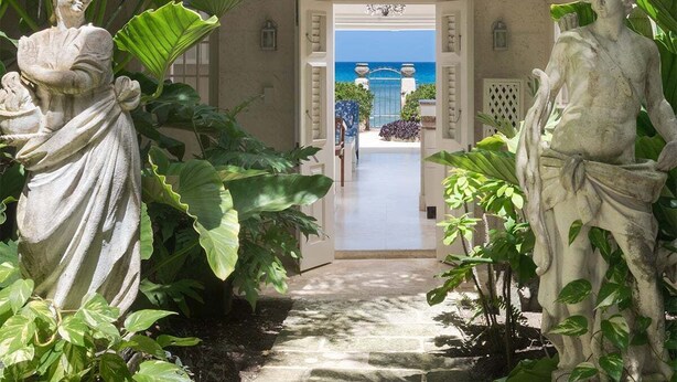 A garden pathway leading to a door with a view of the ocean. - Enchanting Beachfront Retreat - Leamington Cottage (Battaleys)