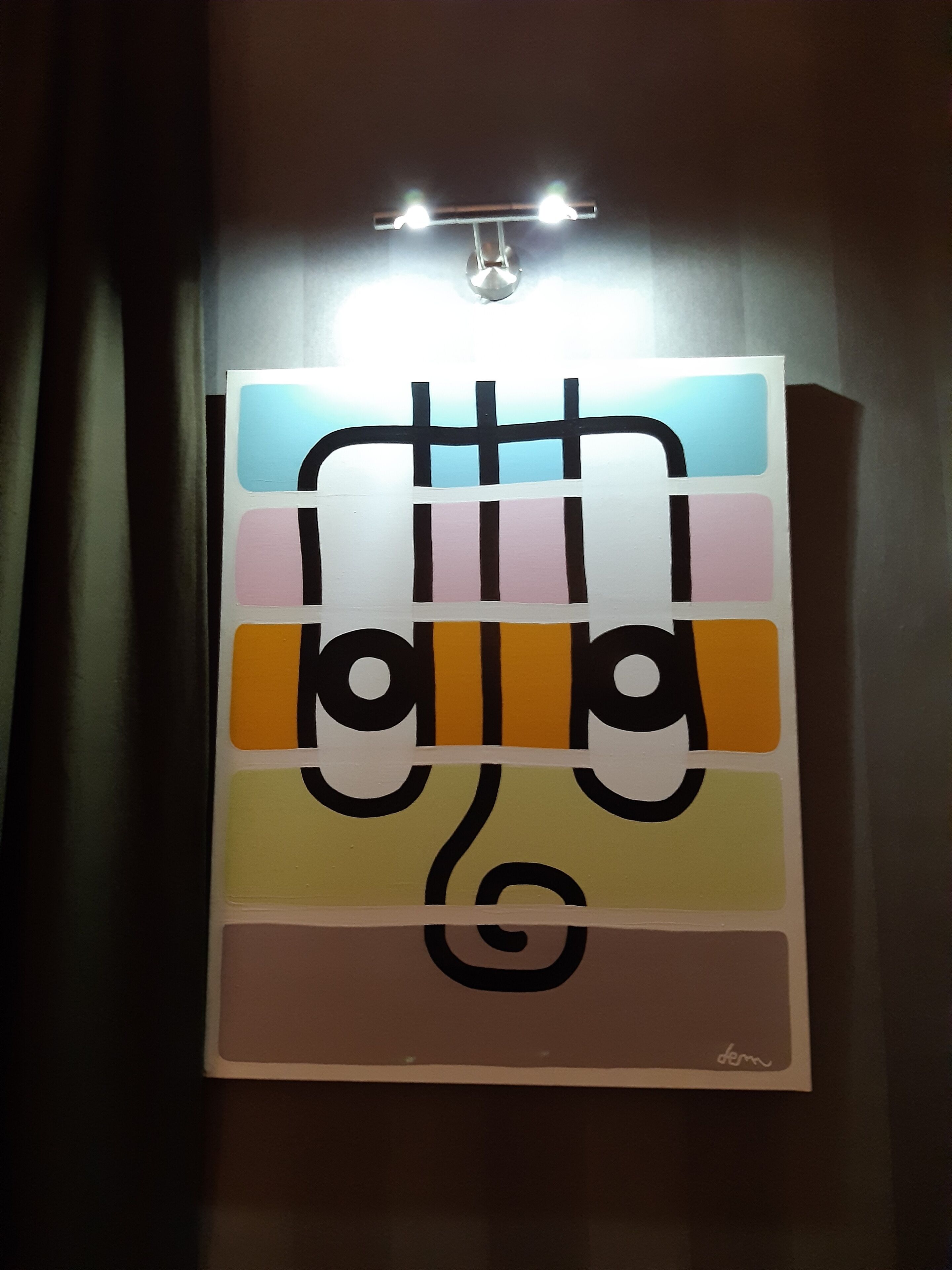 A framed artwork with abstract design and a signature.