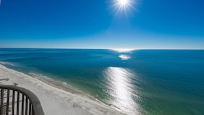 A beach with clear blue water and a sunny sky. - Come RELAX on the LAZY RIVER! Phoenix West 3BR (Orange Beach)