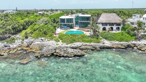 A resort with a pool, modern buildings, and lush greenery. - Stunning Caribbean View with Entrance to Yal-ku Lagoon Akumal (Akumal)