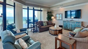 A spacious living room with a large window, a television, and a dining area.