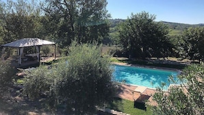 A pool with a pergola and a gazebo in a garden setting. - Villa Gramigna: A charming two-story villa surrounded by the greenery. (Pontecuti)