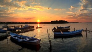 A marina with several boats docked, a sunset in the background, and calm water. - Apartment in Nin with Terrace, Air condition, WIFI (864-3) (Nin)