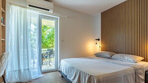 A bedroom with a bed, a window with curtains, a wall-mounted light, and a view of the outdoors. - Apartment in Cres with Balcony, Air condition, WIFI, Washing machine (4249-2) (Cres)