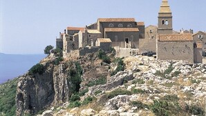 A historic building with a bell tower, situated on a rocky hillside with a view of the sea. - Apartment in Stivan with Terrace, Air condition, WIFI (920-2) (Stivan)
