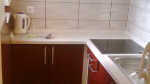 A small kitchen with a sink, a kettle, and cabinets. - Apartment in Lopar with Terrace, Air condition, WIFI (568-4) (Lopar)