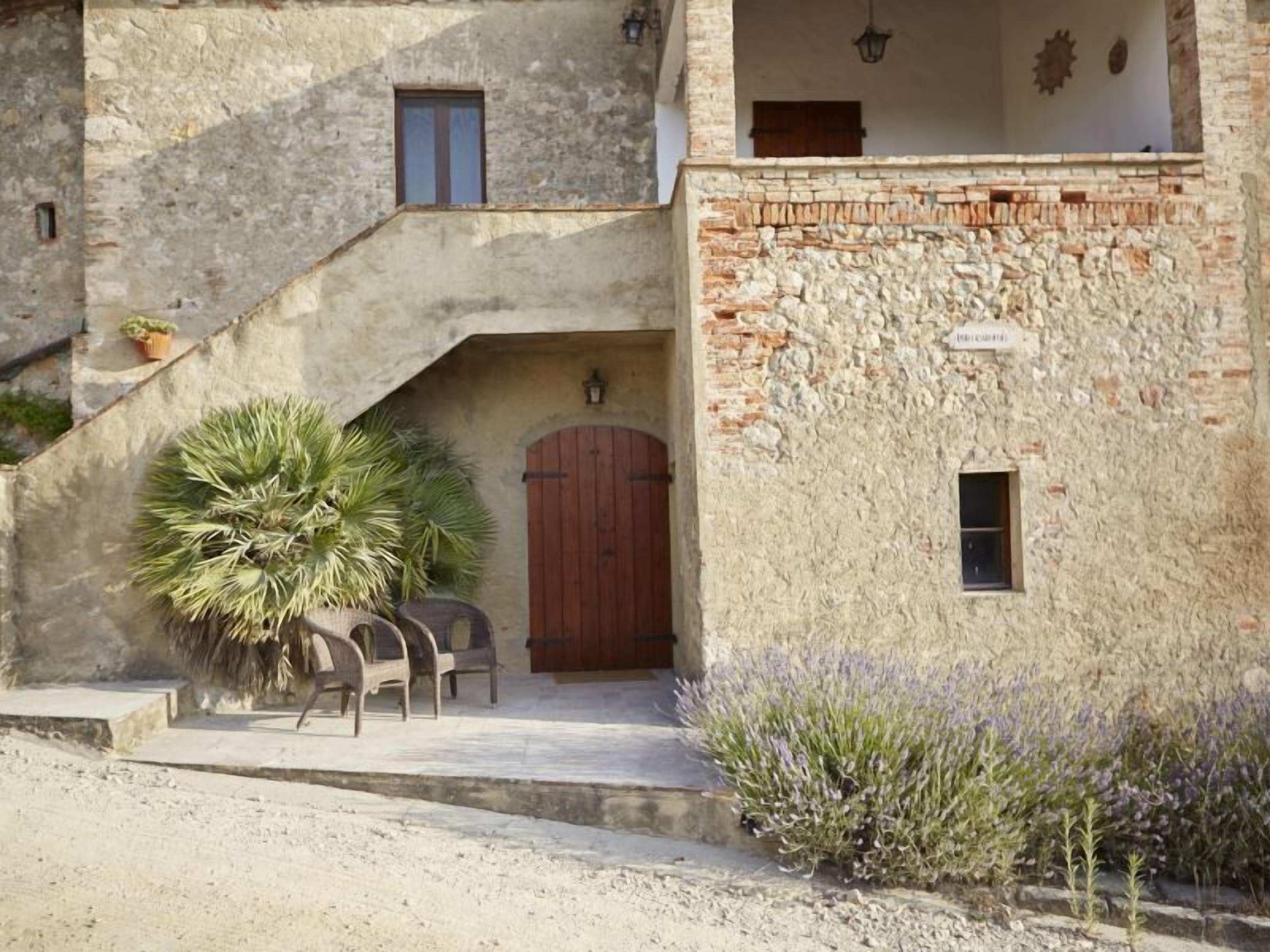 A rustic building with a stone facade, a wooden door, and a small window.