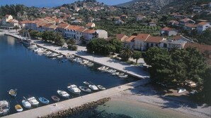 A coastal town with a marina, houses with red-tiled roofs, and a mountain in the background. - Studio apartment in Trpanj with Terrace, Air condition, WIFI, Washing machine (4199-5) (Trpanj)