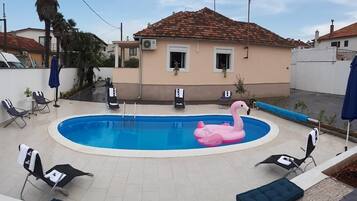 Relax by the pool surrounded by lounge chairs and a fun float.