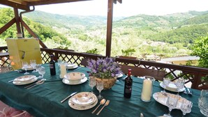 A table set for a meal with a view of a mountainous landscape. - Vacation Home in Nievole with 2 bedrooms sleeps 4 (Nievole)