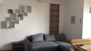 A modern living room with a grey sofa, white shelving units, and a wooden accent wall. - Apartment in Seline with Seaview, WIFI, Washing machine (4209-1) (Seline)