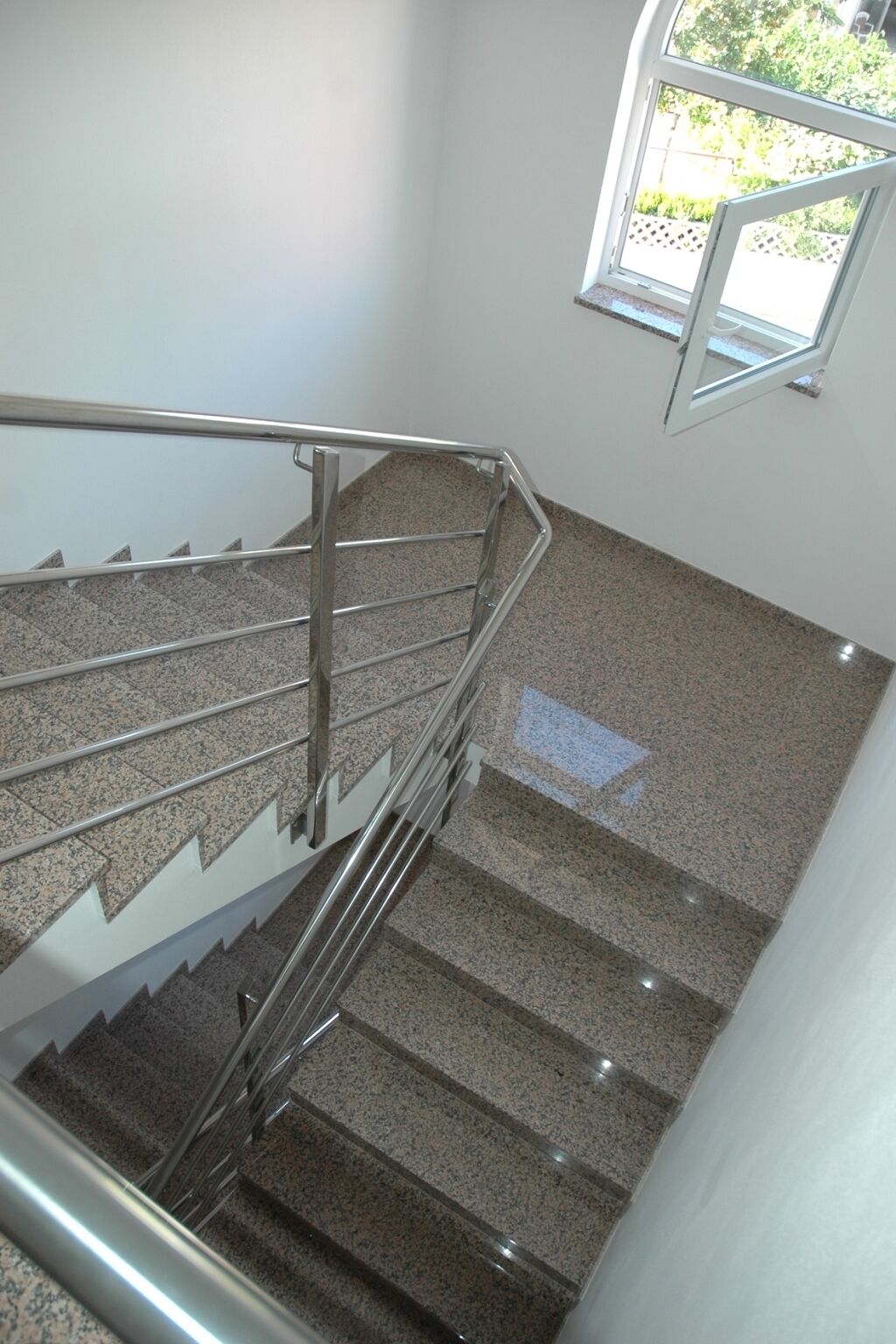 A staircase with metal railings and granite steps.